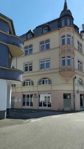 a large tan building with a black roof at NORA One in Traben-Trarbach