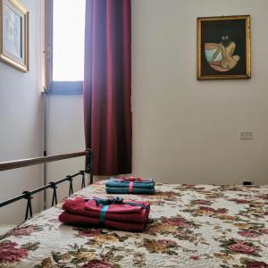 Postel nebo postele na pokoji v ubytování Cortile di San Leo