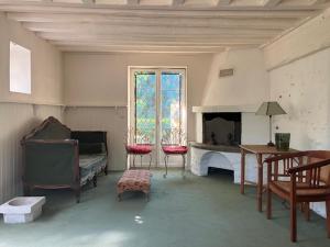 a living room with a couch and a fireplace at cottage à bethemont la foret in Béthemont-la-Forêt