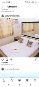 Schlafzimmer mit einem Bett mit weißer Bettwäsche und Kissen in der Unterkunft Pousada Recanto Das Palmeiras in Búzios