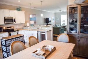 a kitchen with a table and chairs in a room at 3BR Seaside Villas Beach House POOL steps to OCEAN in Atlantic Beach