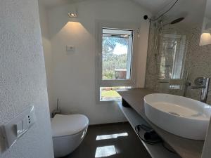 a bathroom with a sink and a toilet and a window at Villa Claudia Torre Delle Stelle in Torre delle Stelle +57 photos