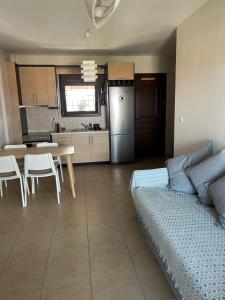 a room with a bed and a kitchen with a table at Stone House in Afytos in Afitos