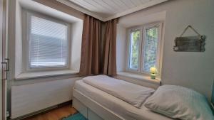 Postel nebo postele na pokoji v ubytování homy Bludenz Downtown Suites