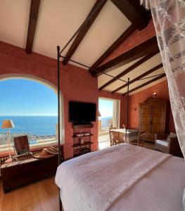 a bedroom with a bed and a view of the ocean at La Casa di Pucci Sanremo in Sanremo