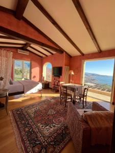a bedroom with a bed and a dining room with a table at La Casa di Pucci Sanremo in Sanremo