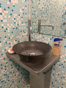 a bathroom with a sink with a faucet at Maison des roses in Oullins