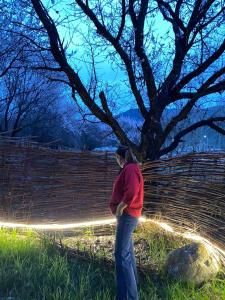 une femme debout devant une clôture dans l'établissement Turan Handmade Yurt with Heated Floors, à Karakol 13 autres photos