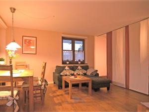 a living room with a couch and a table at Cosy apartment with private garden in Brachthausen in the Sauerland in Brachthausen
