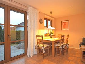a dining room with a wooden table and chairs at Cosy apartment with private garden in Brachthausen in the Sauerland in Brachthausen