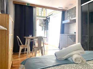 a bedroom with a bed and a table with chairs at Terrace House in Lisbon