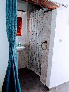 a bathroom with a shower curtain and a sink at Casa Muskoka in Zurgena