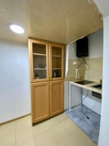 a kitchen with a wooden cabinet in a room at дом в старом тбилиси in Tbilisi City