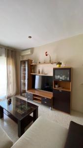 a living room with a coffee table and a tv at Puerto Barrio Alto in El Puerto de Santa María