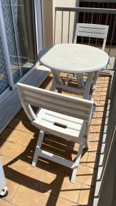 a white table and a chair on a porch at Puerto Barrio Alto in El Puerto de Santa María +9 photos