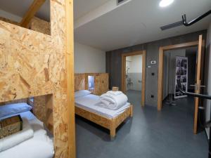 a bedroom with two bunk beds and a hallway at LUMEN ALBERGUE in Mondoñedo