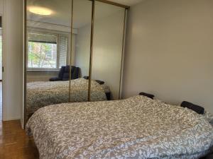 a bedroom with two beds and a mirror at Convenient Stay Helsinki in Helsinki