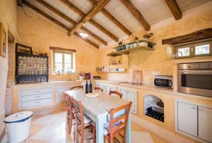una cucina con un tavolo e delle sedie di Villa Dolores, a magnificent Villa, ideal for families and groups a Heki