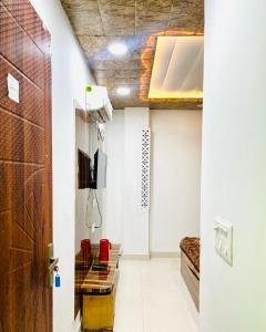 a hallway with a room with a bed and a door at Shri Hari Cottage in Mathura