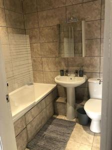 a bathroom with a sink and a toilet and a tub and a sink at Affordable Luxury 1 Stunning apartment Sunderland close to City centre hospital Crown Works Studio and Nissan in Sunderland
