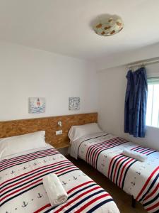A bed or beds in a room at Apartamento cerca del mar