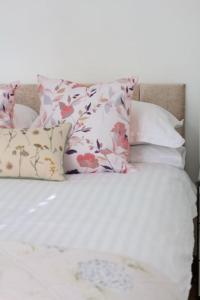 een bed met witte lakens en kussens erop bij The Luxury Dartmoor Den, Dartmoor, Devon in Ashburton
