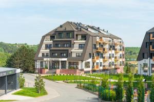 a large apartment building in the middle of a street at Fruške Residences in Vrdnik
