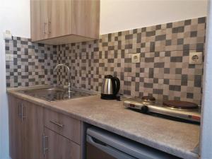 a kitchen with a sink and a counter top at Nikos Apartments 3 in Kavos