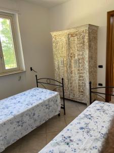 a bedroom with two beds and a window at Villa Laurus in Torre dell'Orso