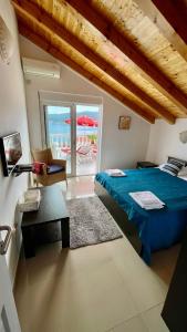 a bedroom with a blue bed and a view of the ocean at Family House with pool & sea view in Bijela