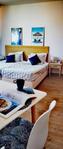 a bedroom with a bed and a table and chairs at F 207 Primorsko del Sol - просторно студио с кухня in Primorsko
