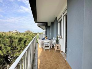 a balcony with a table and chairs on it at Residence Oceanico in Lignano Sabbiadoro