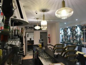a restaurant with a bar with chairs and lights at le paris saint ouen in Paris