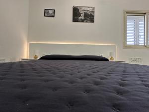 Voodi või voodid majutusasutuse LXR Rooms Carloforte toas