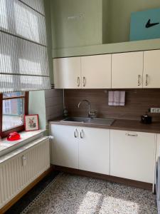 a kitchen with white cabinets and a sink at Wohlfühlen in historischem Haus in Brake