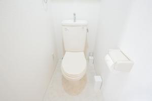 a white bathroom with a toilet and a sink at walk to Ushigome-yanagicho sta. EoWh in Tokyo +6 photos