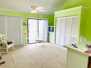 a living room with green walls and a ceiling at Cozy Little River Condo in Little River
