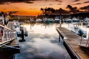 a group of boats docked in a marina at sunset at Cozy Little River Condo in Little River