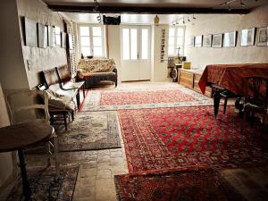 a living room with a table and a rug at Maison Beurdelaine in Avallon