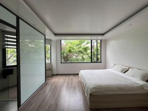 a bedroom with a bed and a large window at Rosemary's in Ha Long +50 photos
