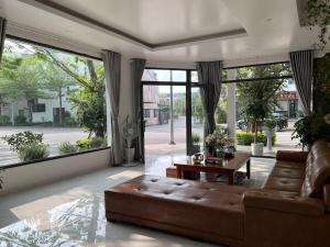 a living room with a couch and a large window at Rosemary's in Ha Long