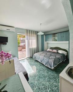 a bedroom with a bed and a sink at Apartmani Mediteran in Vrh