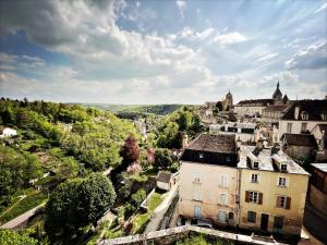 an aerial view of a town with buildings and trees at Maison Beurdelaine in Avallon