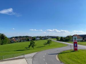 a winding road with a gas station on the side at Wohnung City Nord mit Balkon in Herzogsdorf