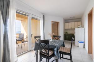 a kitchen and dining room with a table and chairs at Apartments Josipa in Mandre