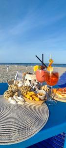 a picnic table with food and drinks on the beach at Camping Ancora in Comacchio