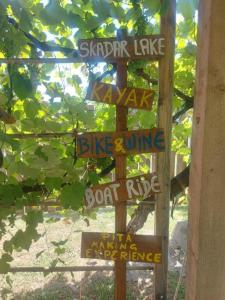 a wooden sign with street signs on it at Village Serenity Cottage with outside toilet in Podgorica