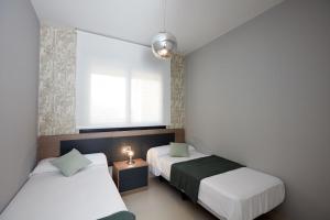 a bedroom with two beds and a window at Amazing Apartment in Benidorm - Sunset in Benidorm +11 photos