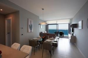a dining room and living room with a table and chairs at Amazing Apartment in Benidorm - Sunset in Benidorm