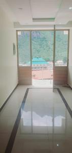 an empty room with a view of a large window at New Hilton Hotel in Naran